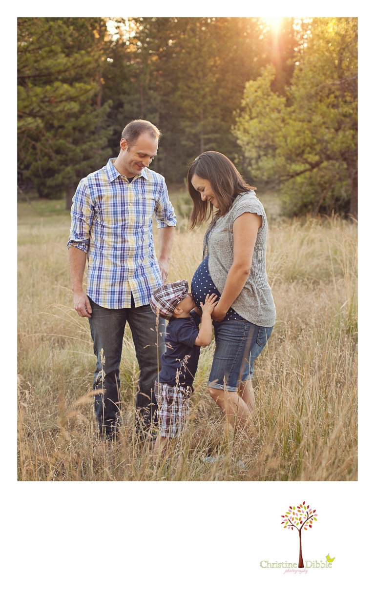 Big brother kissing baby bump