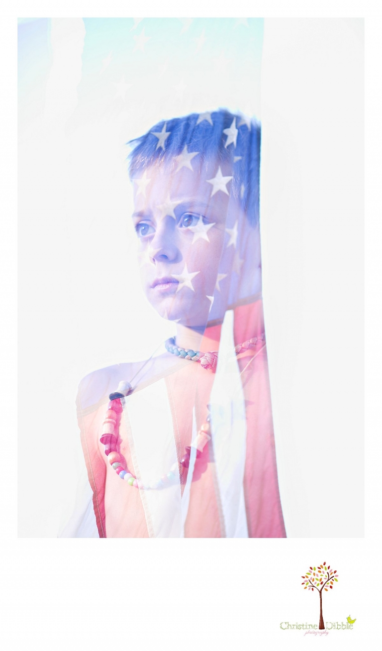 Sonora childrens photographer Christine Dibble Photography takes a double exposure portrait of a child and an American flag on the shore of Lake Tahoe.