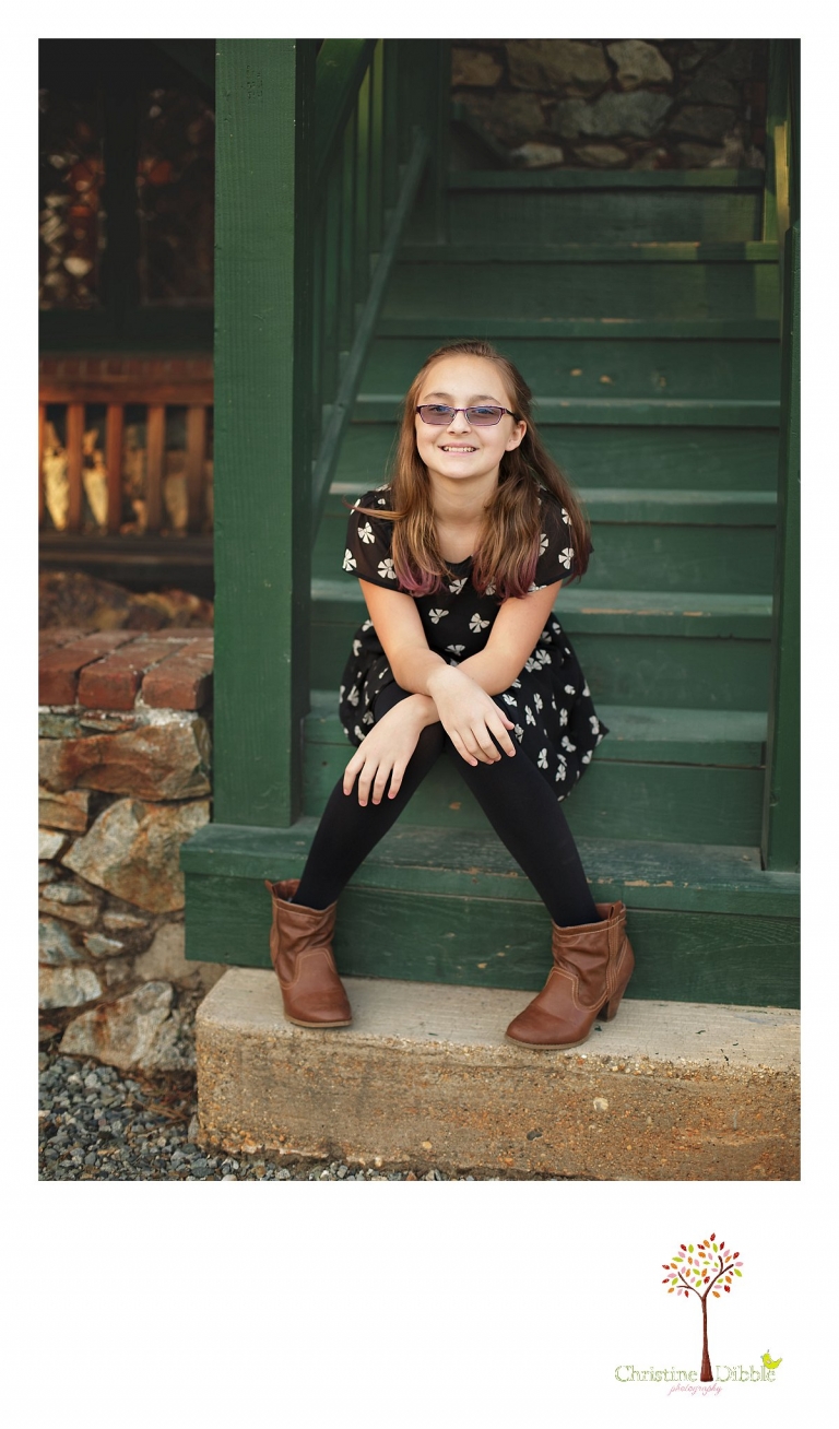 Sonora and Grass Valley children's photographer Christine Dibble Photography takes photos of a pre-teen girl on the steps at Empire Mine State Park.