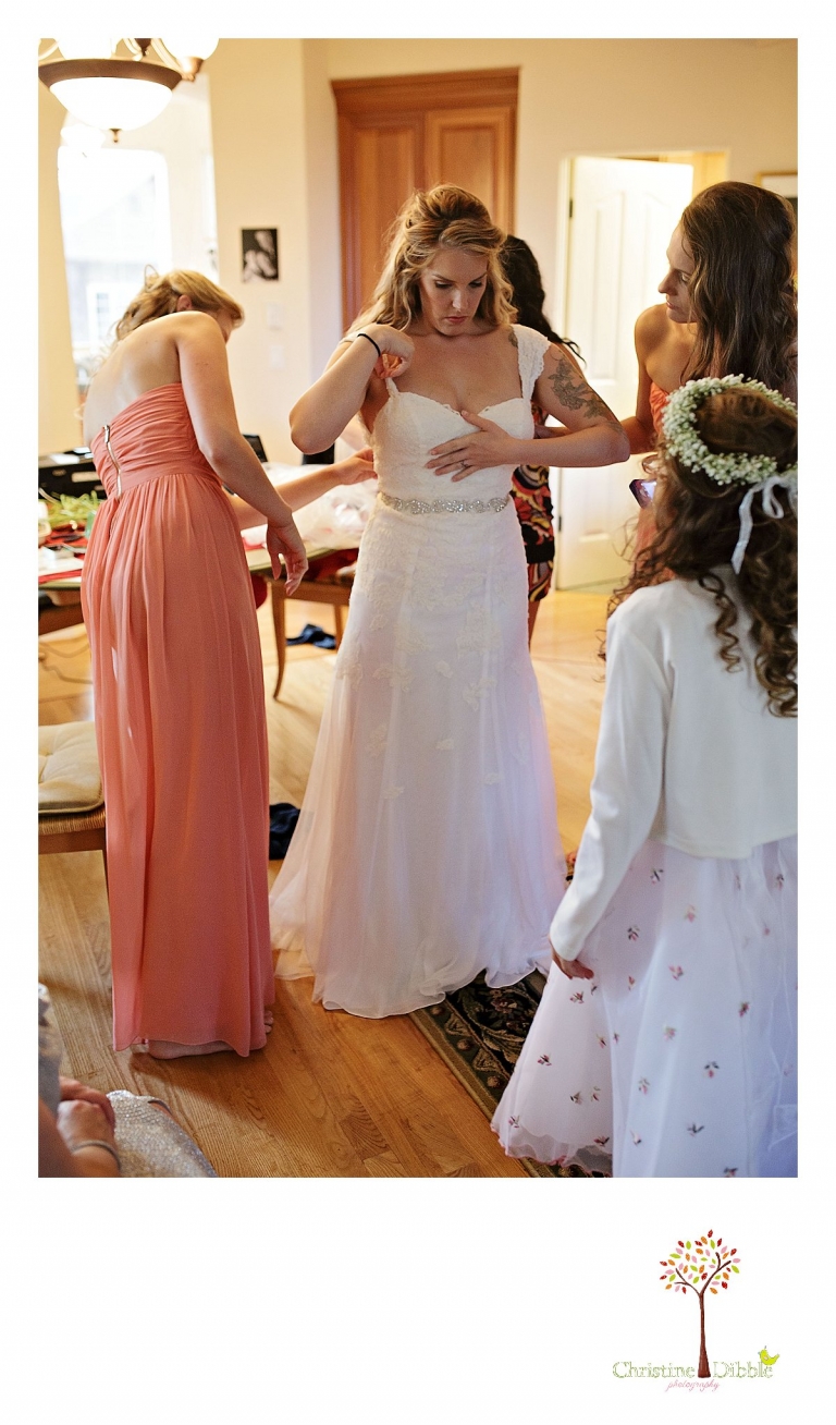 Sonora wedding photographer Christine Dibble Photography  photographs the bride getting dressed for  a sunset beach wedding at Moran Lake Beach in Santa Cruz.