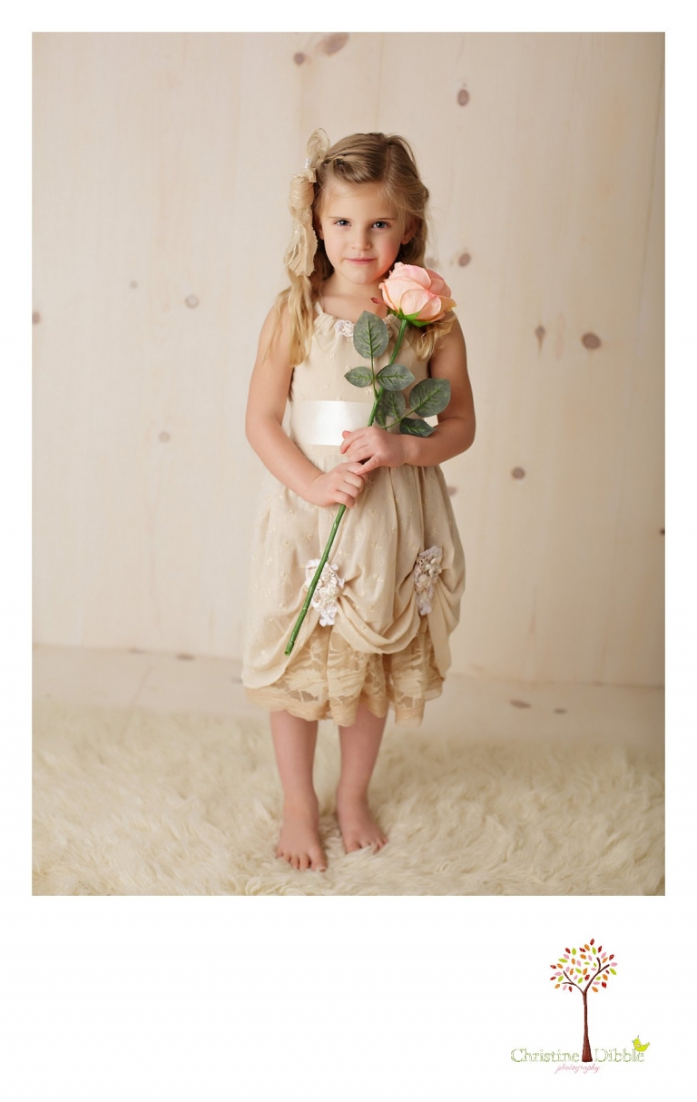 Sonora childrens photographer Christine Dibble Photography takes photos of a girl in a hand crafted flower girl dress made by Hopefully Romantic.