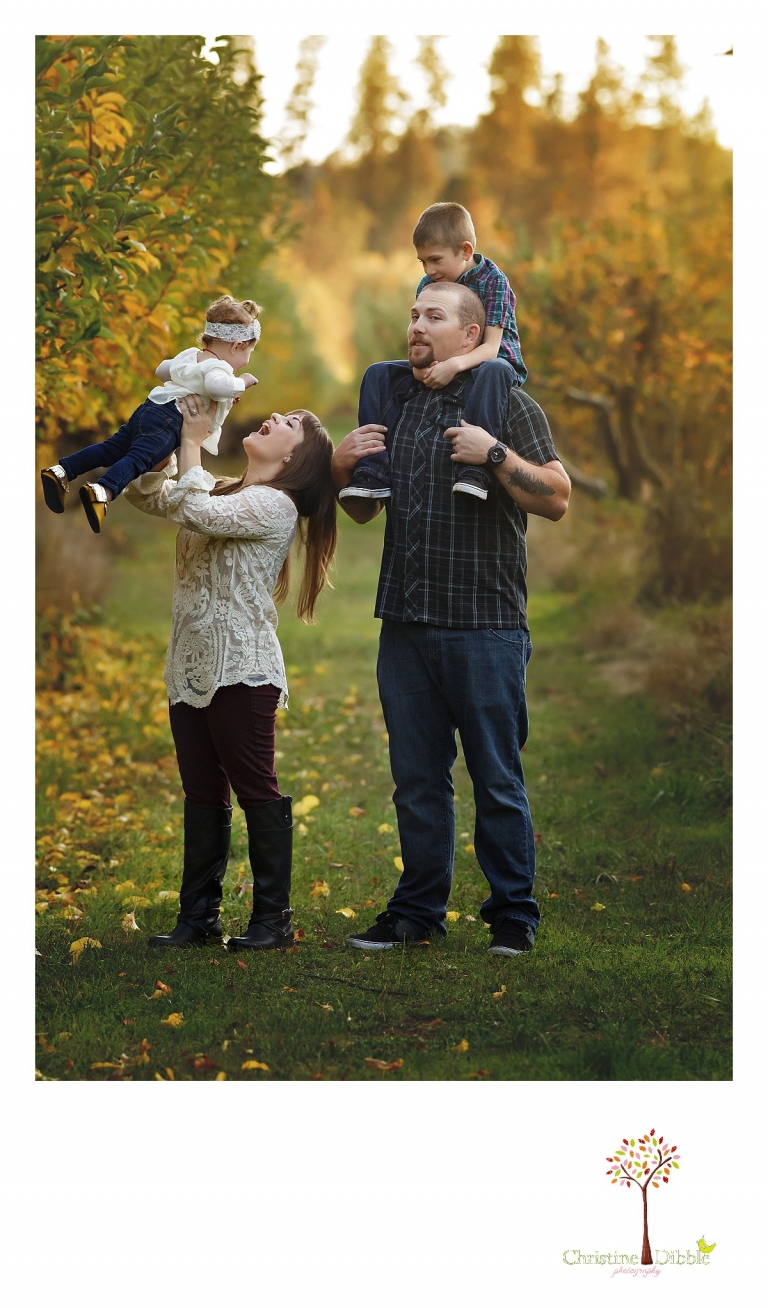 A family goofs off during a Sonora family photography session photographed by Christine Dibble Photography at Indigeny Reserve in the fall among the apple orchards.