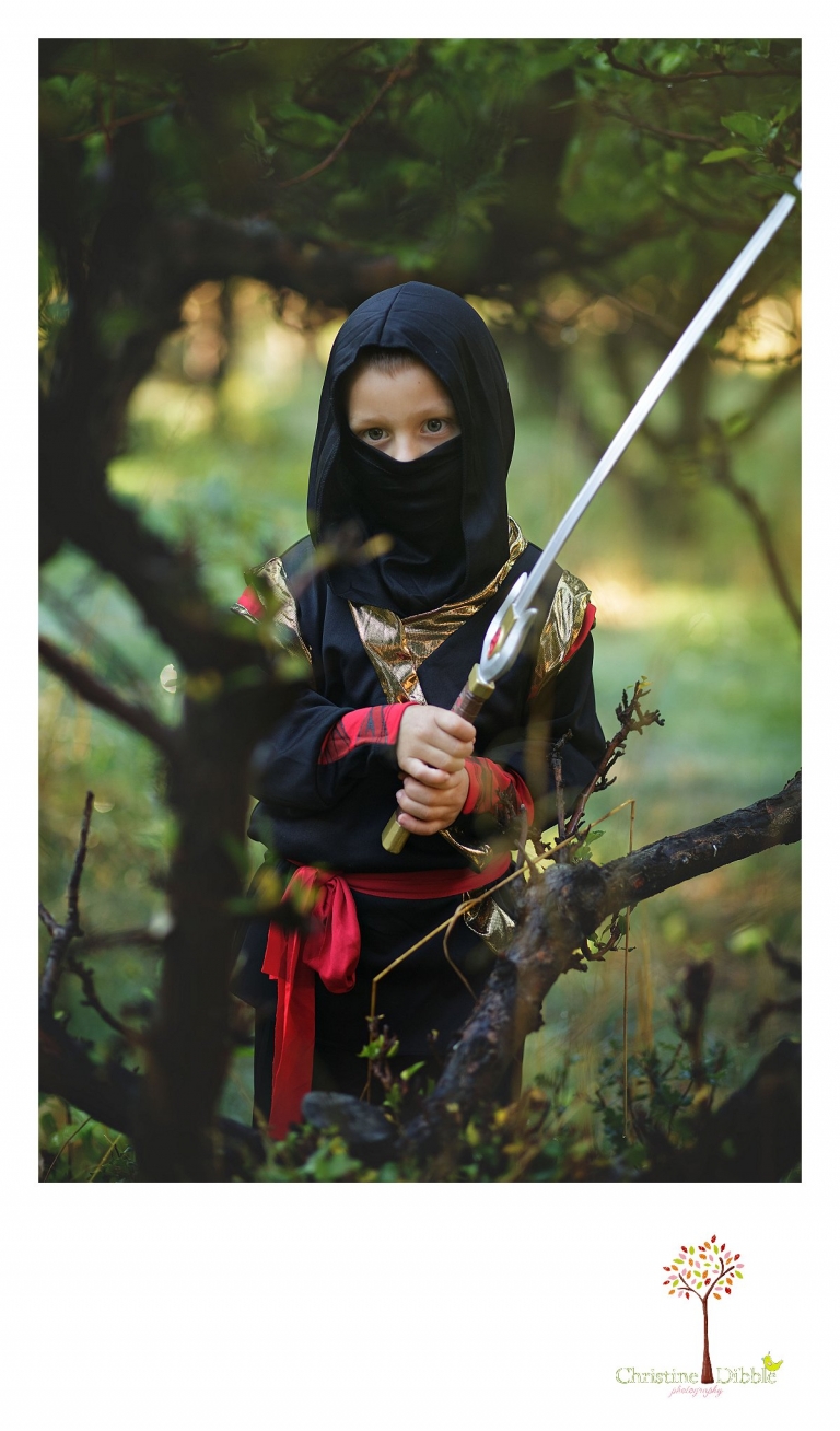 Sonora childrens photographer Christine Dibble Photography takes photos of a ninja in his Halloween costume among the apple trees at Indigeny Reserve.