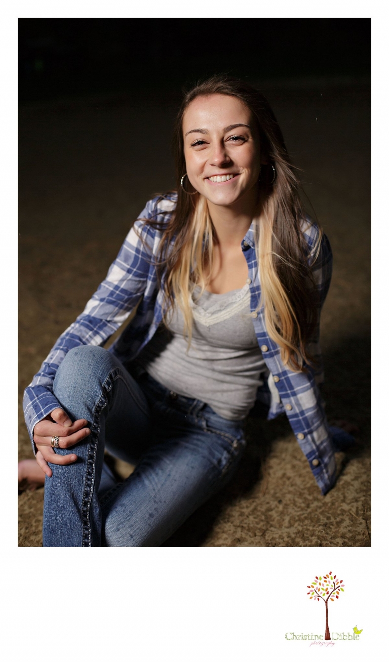 Sonora senior portrait photographer Christine Dibble Photography takes photos outside with lights in a dark rain storm at Jeness Park in the Sierra Nevada Mountains near Cold Springs.