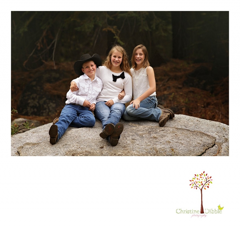 Children pose for a sibling photo on a large rock at Aspen Meadows Pack Station while photographed by Christine Dibble Photography, Sonora photographer.