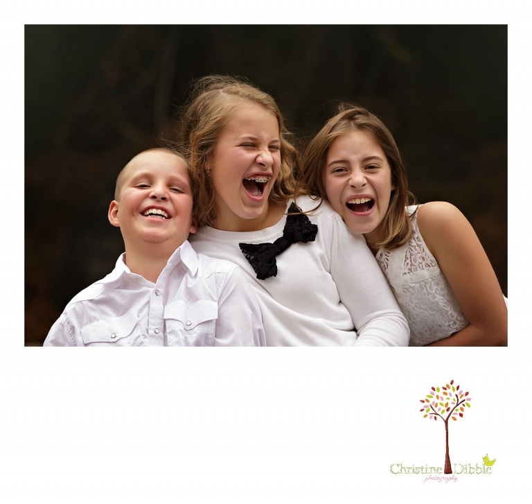 Three children laugh during a family photography session with Christine Dibble Photography of Sonora at Aspen Meadows Pack Station.