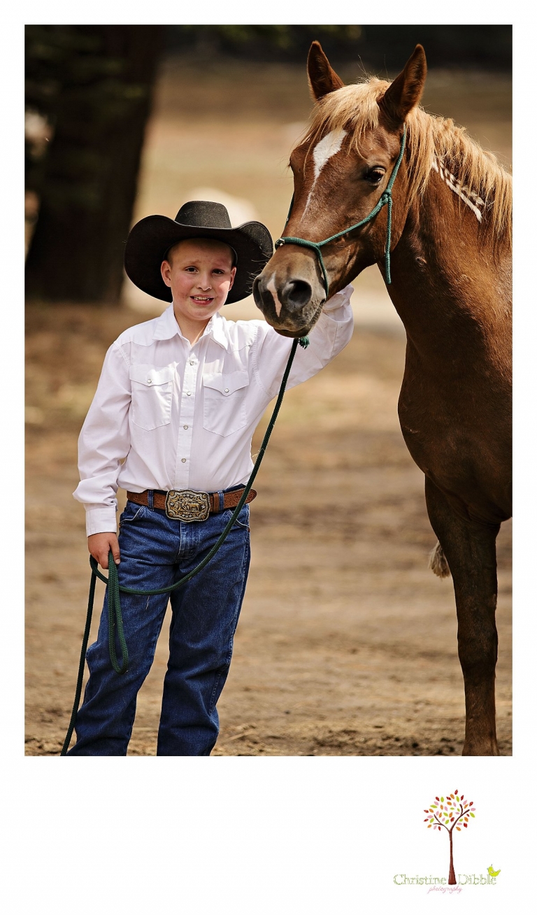 A little cowboy poses for a photo with his horse at Aspen Meadows taken by Christine Dibble Photography of Sonora.
