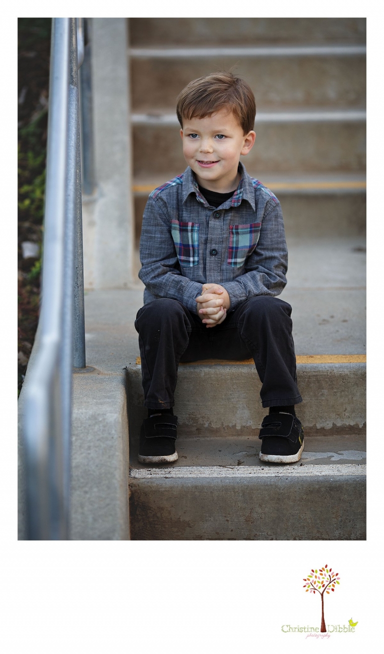 Sonora photography by Christine Dibble Photography captures photos of a little boy sitting on a cement staircase during mini sessions at Sierra College in Grass Valley.