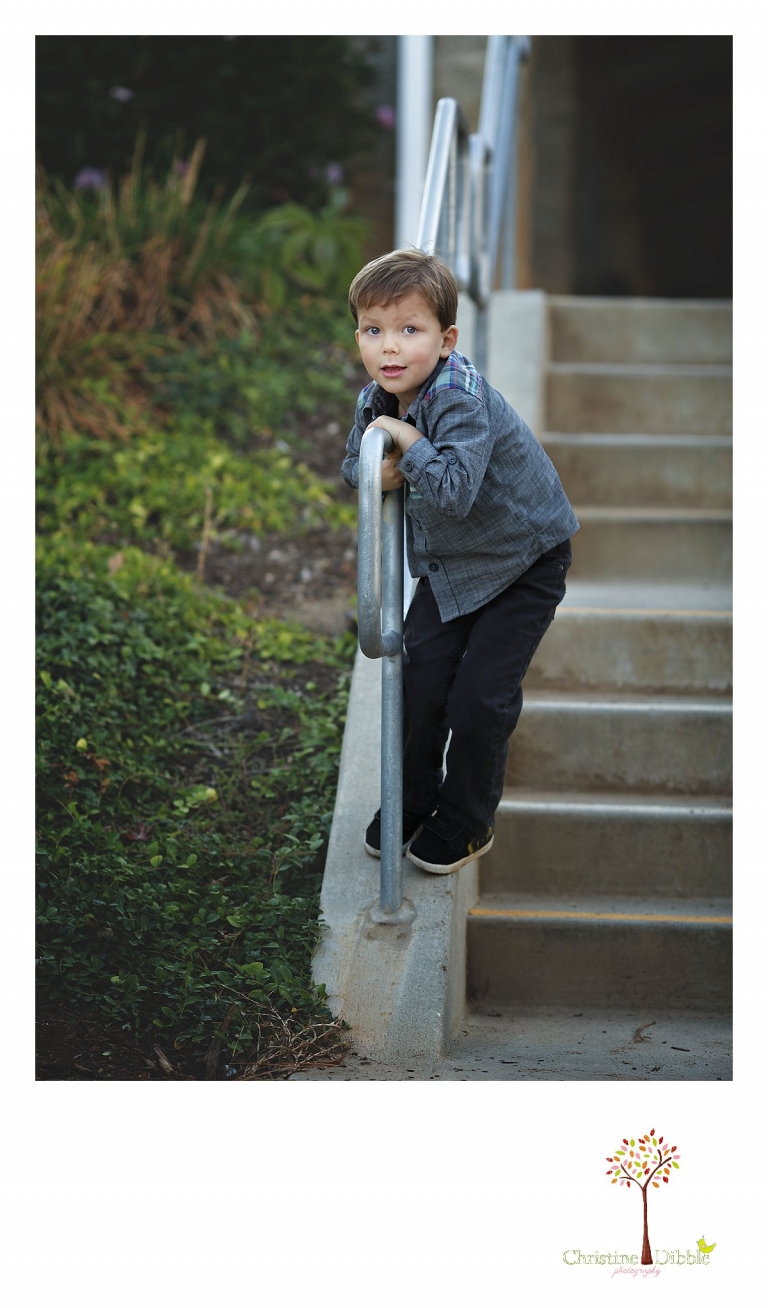 Sonora photography by Christine Dibble Photography captures photos of a little boy playing on a stair railing during mini sessions at Sierra College in Grass Valley.