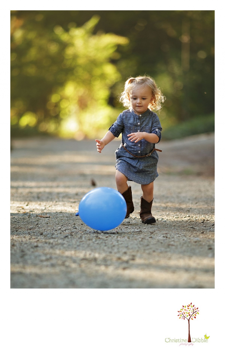 Sonora photography by Christine Dibble Photography captures photos of a little girl chasing a balloon during mini sessions at Empire Mine State Park in Grass Valley.