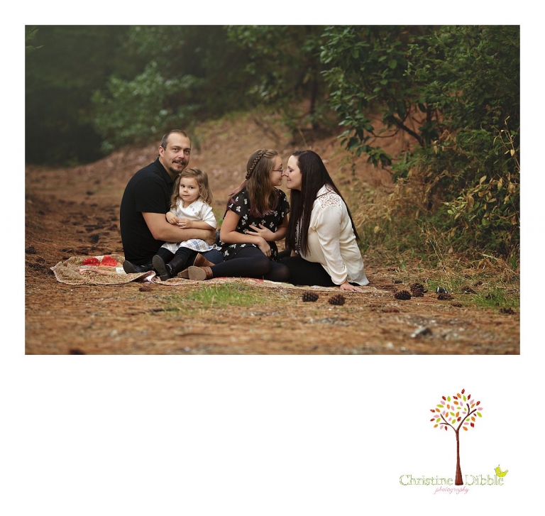 Sonora photography by Christine Dibble Photography captures photos of a family cuddling on a quilt during mini sessions at Empire Mine State Park in Grass Valley.