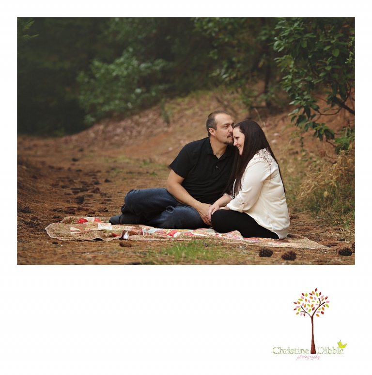 Sonora photography by Christine Dibble Photography captures photos of a mom and dad sharing a kiss during mini sessions at Empire Mine State Park in Grass Valley.