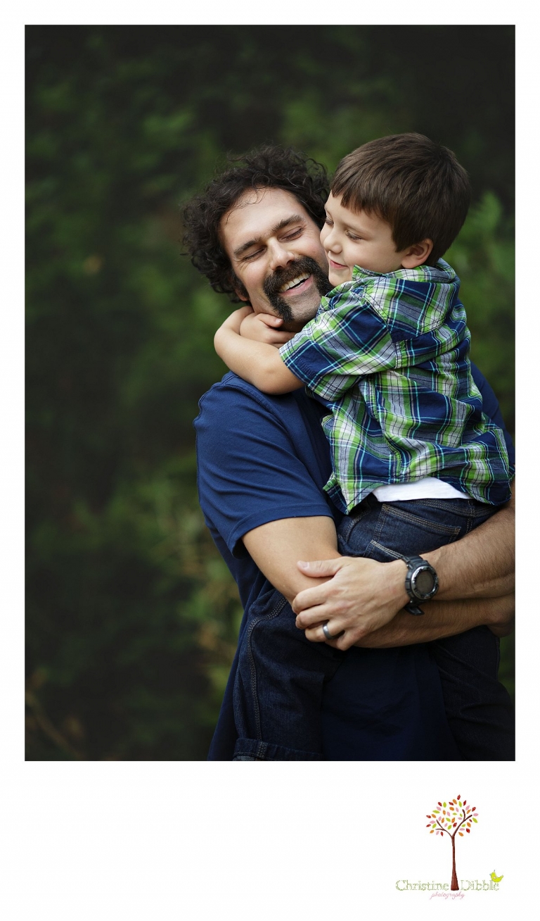 Sonora photography by Christine Dibble Photography captures photos of a dad hugging his little boy during mini sessions at Empire Mine State Park in Grass Valley.
