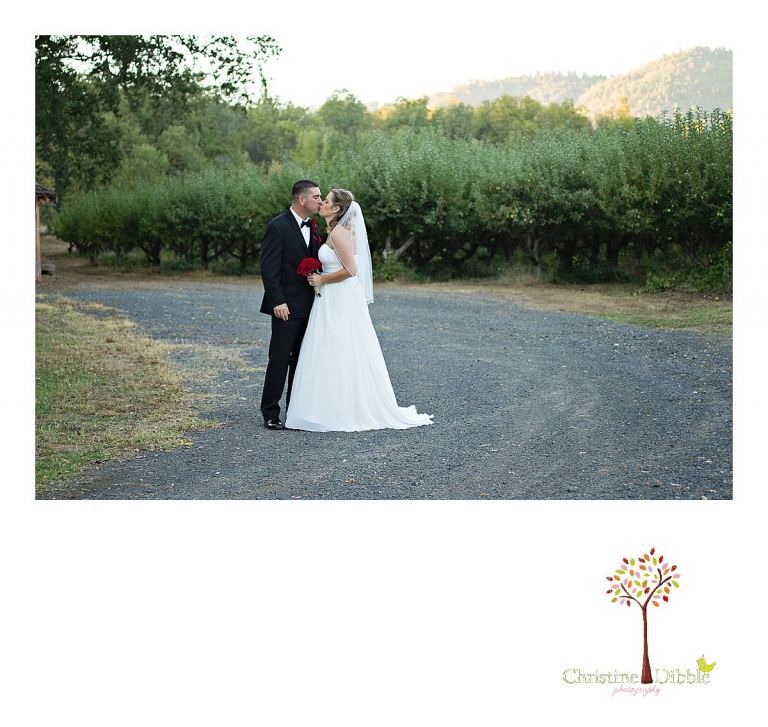 Christine Dibble Photography of Sonora photographs a bride and groom as they walk the orchards after their Indigeny Reserve wedding ceremony.