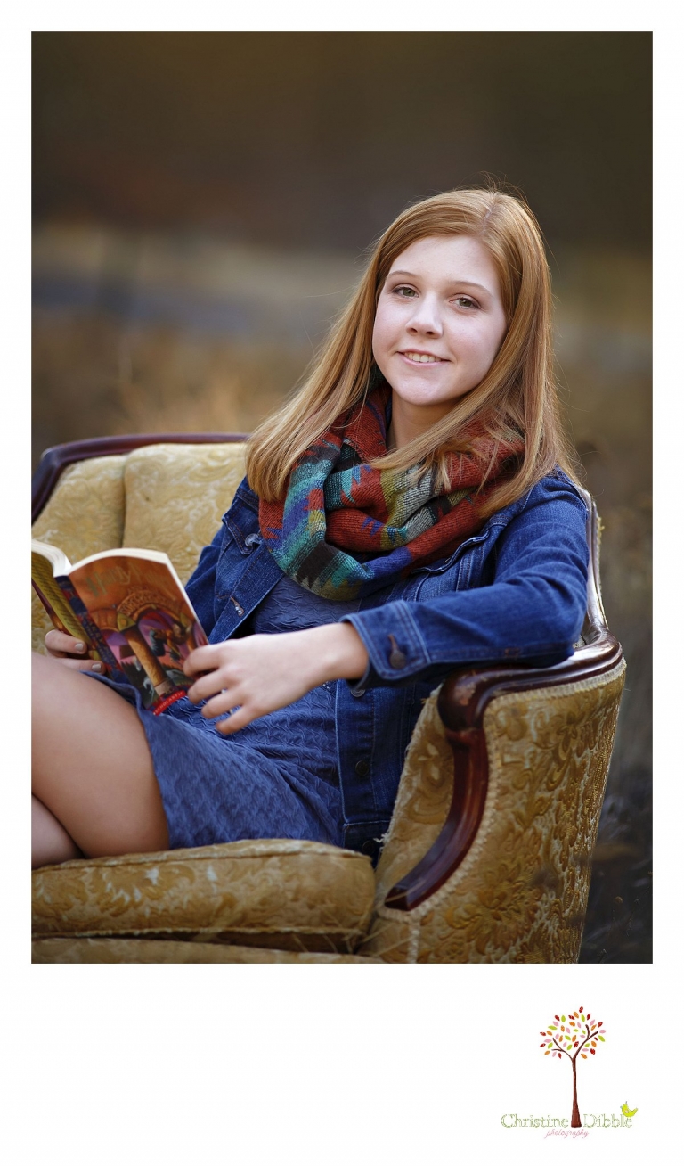 Sonora and Turlock senior portrait photographer Christine Dibble Photography takes outdoor fall senior photos of a girl in an antique chair in a field.