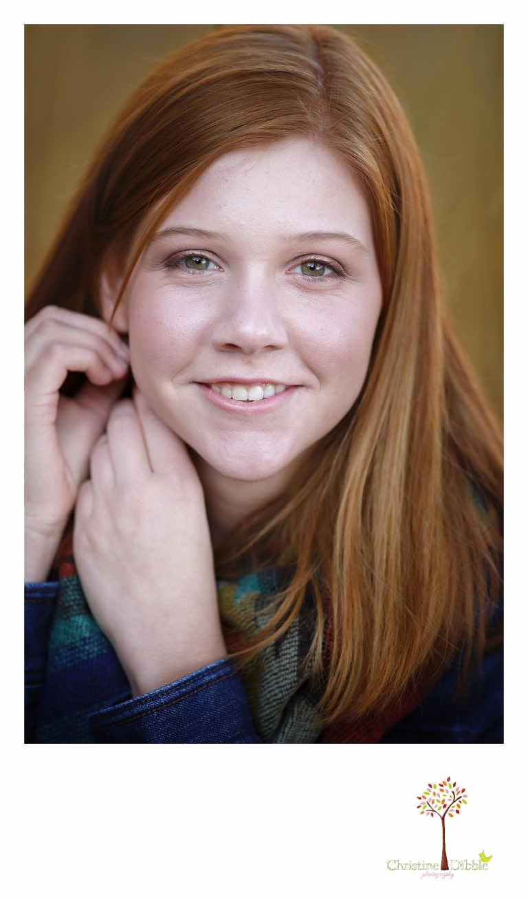Sonora and Turlock senior portrait photographer Christine Dibble Photography takes a head shot during outdoor fall senior photos of a red head with green eyes.