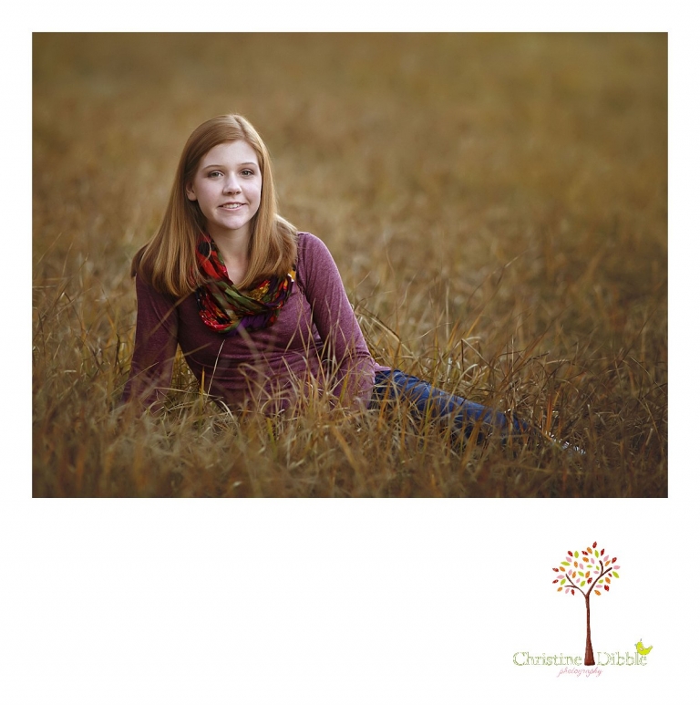 Sonora and Turlock senior portrait photographer Christine Dibble Photography takes outdoor fall senior photos of a girl in purple sitting in a grassy field.