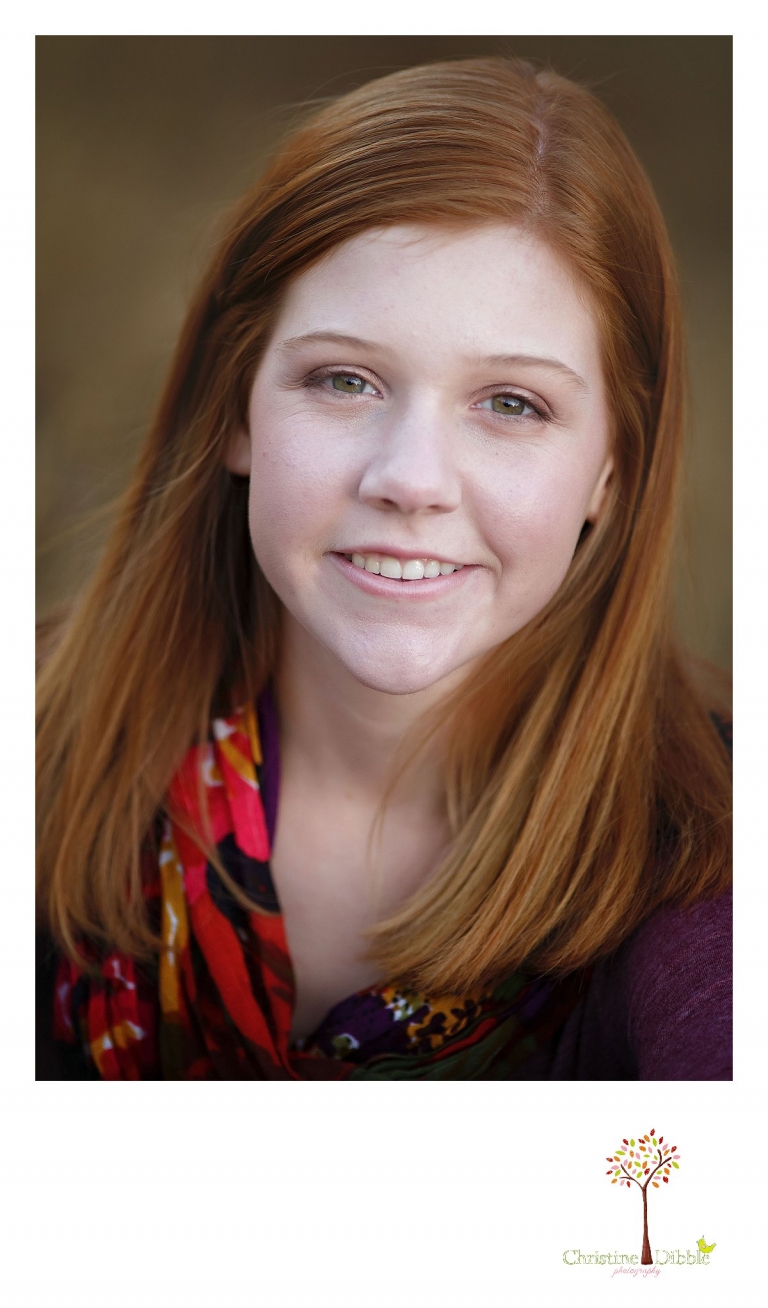 Sonora and Turlock senior portrait photographer Christine Dibble Photography takes outdoor fall senior photos of a red headed girl with beautiful green eyes.