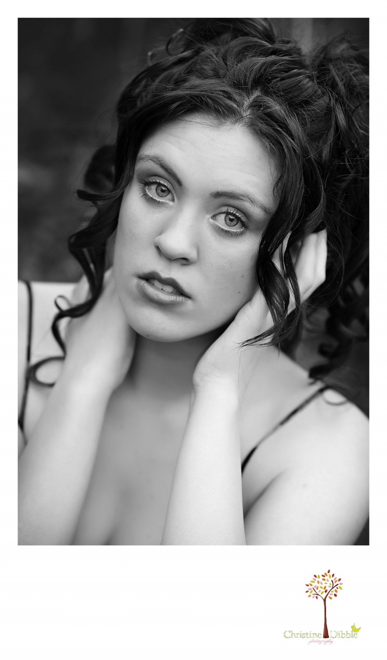 Sonora, CA senior model photographer Christine Dibble takes outdoor modeling photos of a teenage girl for a modeling portfolio while she wears Free People from Tar Flat Antiques for a black and white head shot.