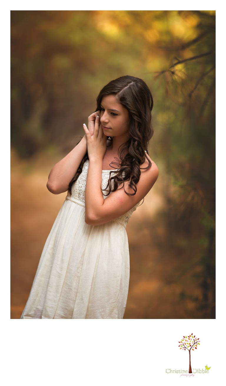 Sonora, Summerville and Turlock senior portrait photographer Christine Dibble Photography takes outdoor senior photos of a Turlock senior girl in a white dress in a golden field near Twain Harte.