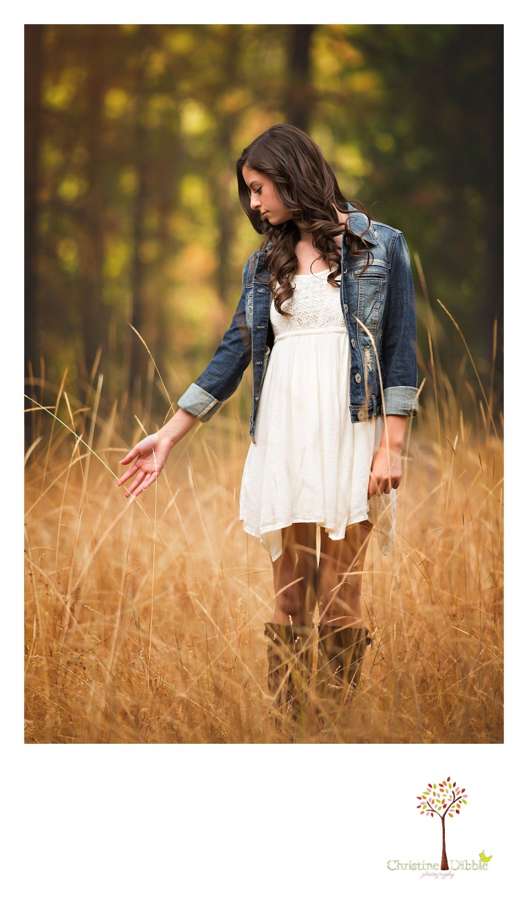 Best Sonora, Summerville and Turlock senior portrait photographer Christine Dibble Photography takes outdoor senior photos of a girl in a sundress and denim jacket and cowboy boots in a Twain Harte field.