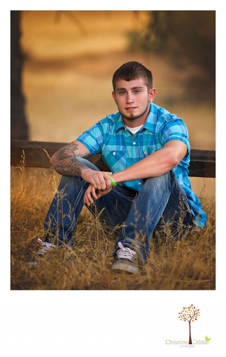 Sonora, Summerville and Turlock senior portrait photographer Christine Dibble Photography takes outdoor senior photos of a blue-eyed senior boy wearing a blue plaid shirt.