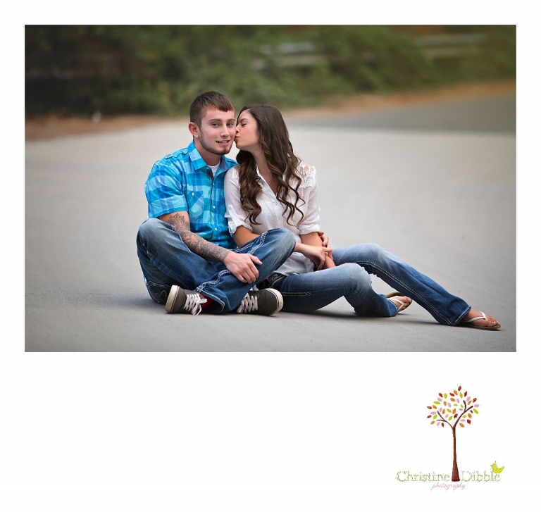 Sonora, Summerville and Turlock senior portrait photographer Christine Dibble Photography takes outdoor senior photos of a senior girl kissing her senior boyfriend during a joint senior portrait photography session.
