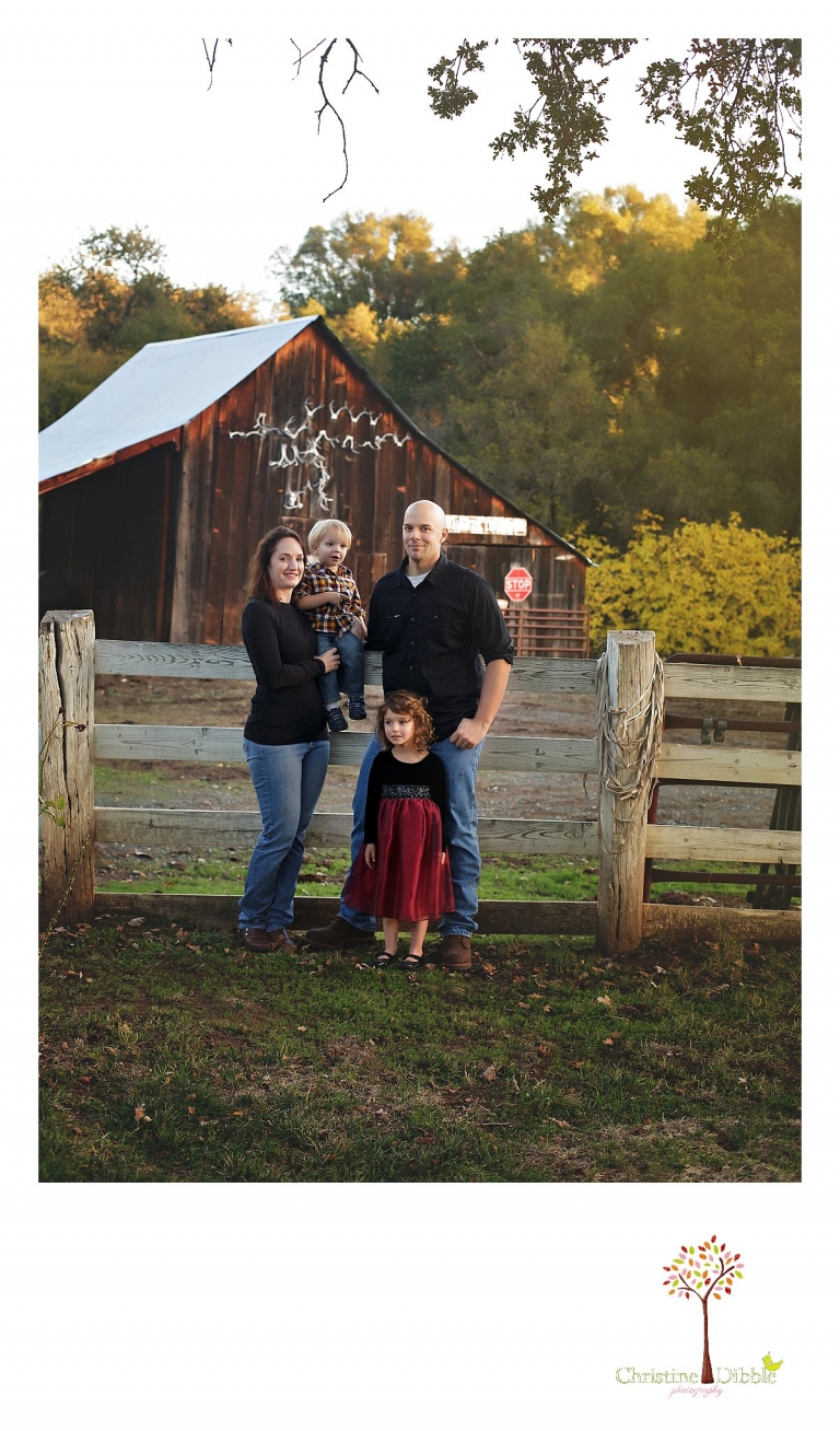 Best Sonora family photographer Christine Dibble Photography photographs a family in front of a barn covered in antlers.