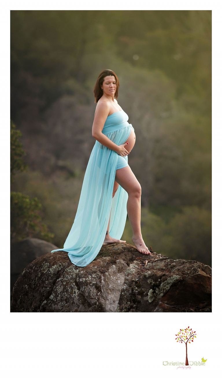 Sonora, CA maternity photography sessions by Christine Dibble Photography can include photos of moms-to-be on granite rocks in a natural setting while wearing flowy dresses to expose the round belly.
