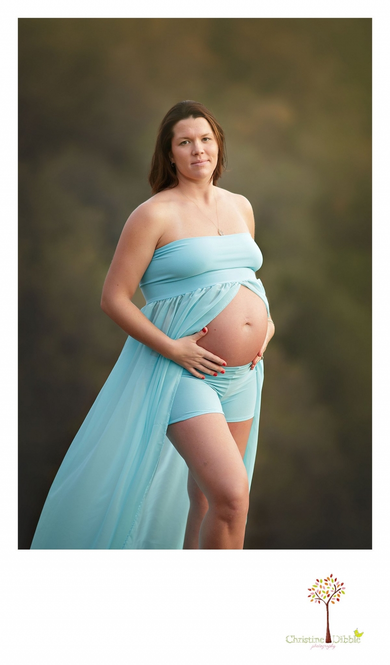 A mom-to-be poses to show her baby belly bump for a Sonora, CA maternity photography session by Christine Dibble Photography.