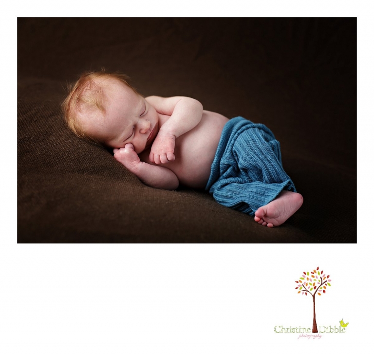 Best Sonora, CA newborn photographer Christine Dibble Photography takes studio photos of a baby boy as he sleeps in upcycled pants during his newborn photography session.
