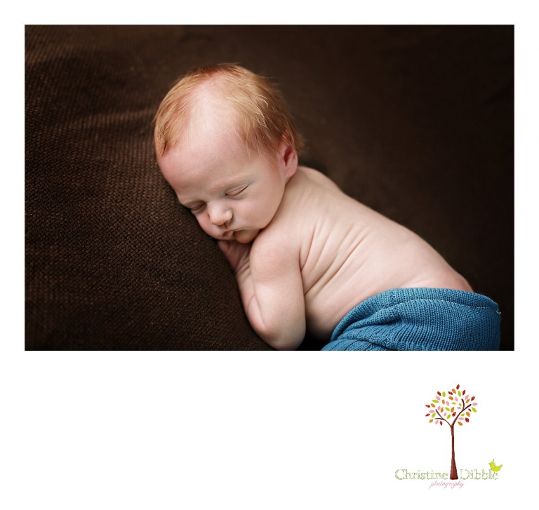 Best Sonora, CA newborn photographer Christine Dibble Photography takes studio photos of a baby boy as he sleeps in upcycled pants during his newborn photography session.