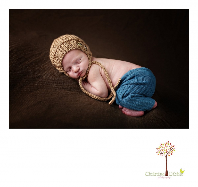 Best Sonora, CA newborn photographer Christine Dibble Photography takes studio photos of a baby boy as he sleeps in upcycled pants and a hat from the Primrose Bunny during his newborn photography session.