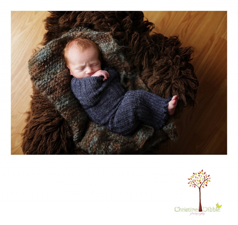 Best Sonora, CA newborn photographer Christine Dibble Photography takes studio photos of a baby boy as he sleeps in a basket filled with flokati fur and a hand knit layering piece  during his newborn photography session.