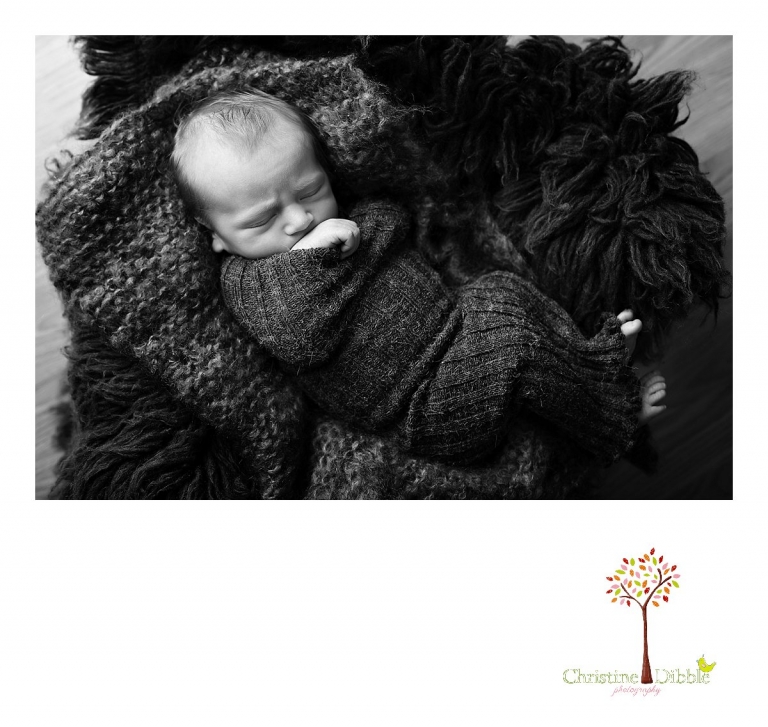 Best Sonora, CA newborn photographer Christine Dibble Photography takes studio photos of a baby boy as he sleeps in a black and white image during his newborn photography session.
