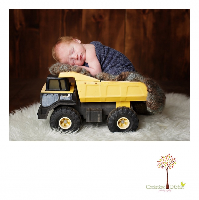 Best Sonora, CA newborn photographer Christine Dibble Photography takes studio photos of a baby boy in a vintage Tonka dump truck during his newborn photography session.