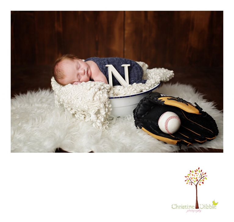 Best Sonora, CA newborn photographer Christine Dibble Photography takes studio photos of a baby boy with baseball gear during his newborn photography session.