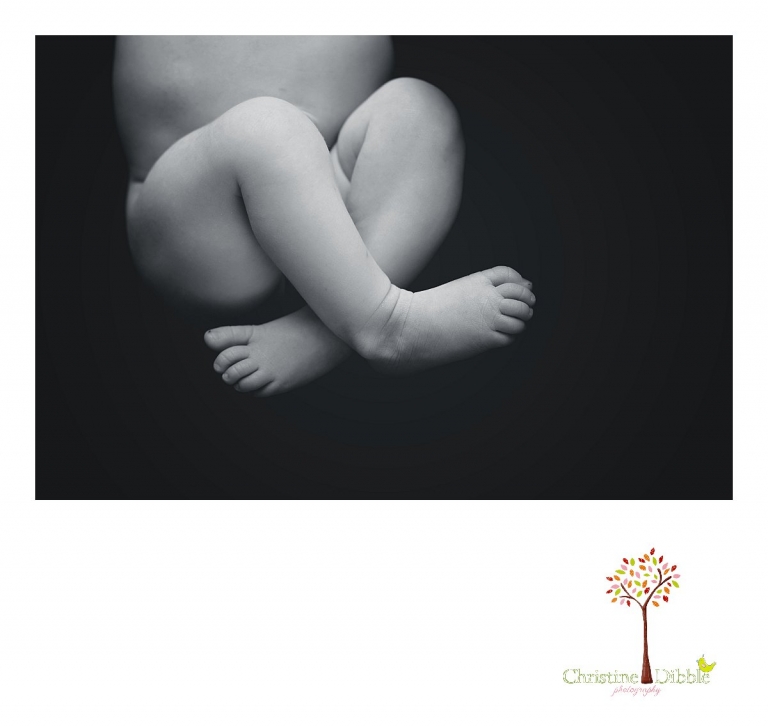 Sonora, CA newborn photography session by best Sonora newborn photographer Christine Dibble Photography includes a black and white dramatic image of tiny baby feet and toes.