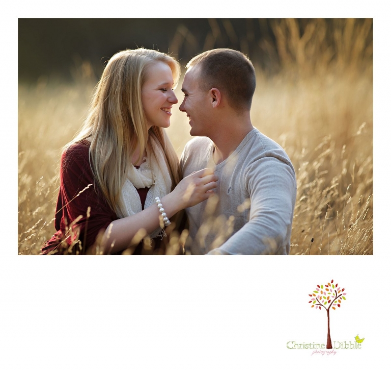 Sonora, CA couple's and engagement photographer Christine Dibble Photography takes romantic engagement style photos of a couple laughing in a field near Twain Harte at sunset.