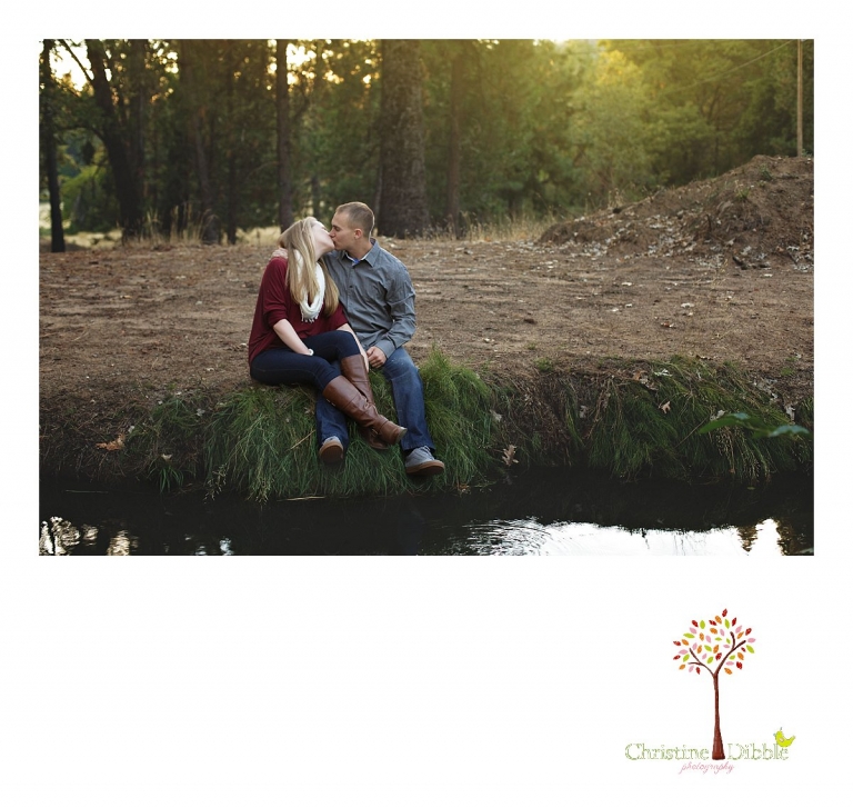 Sonora, CA couple's and engagement photographer Christine Dibble Photography takes romantic engagement style photos of a couple kissing on the bank of a river Twain Harte at sunset.