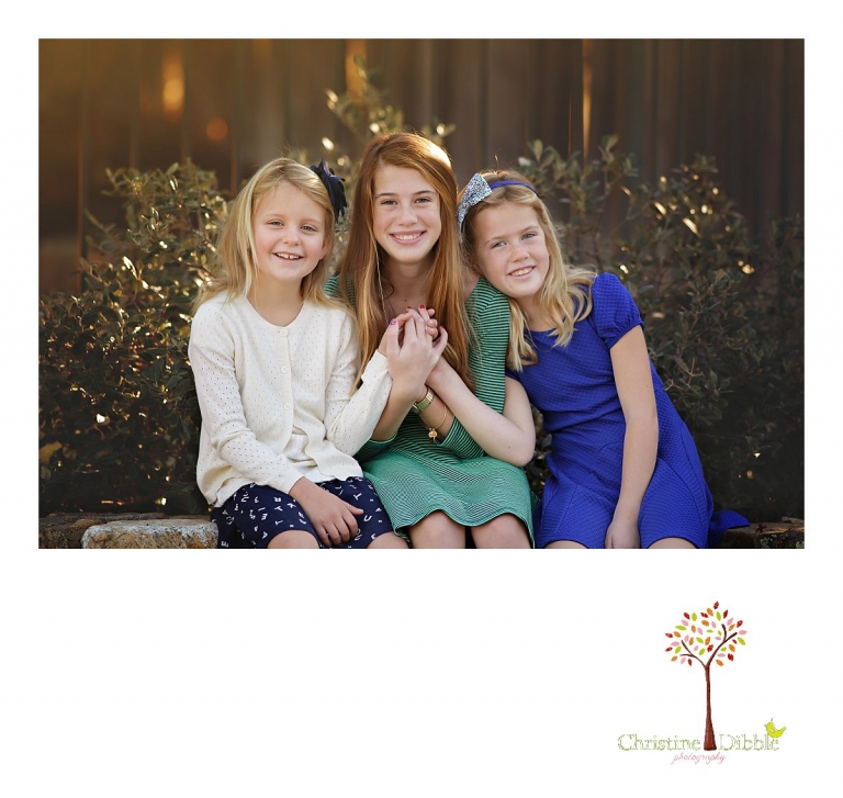 Christine Dibble Photography, best Sonora family photographer, takes outdoor portraits of new sisters during a blended family photo session in their renovated backyard in Tuolumne.