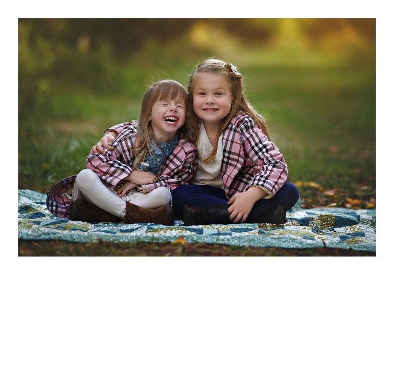 Two sisters giggle and laugh together for a sibling portrait taken during a Sonora, CA family photography session at Indigeny Reserve by Christine Dibble Photography last fall.
