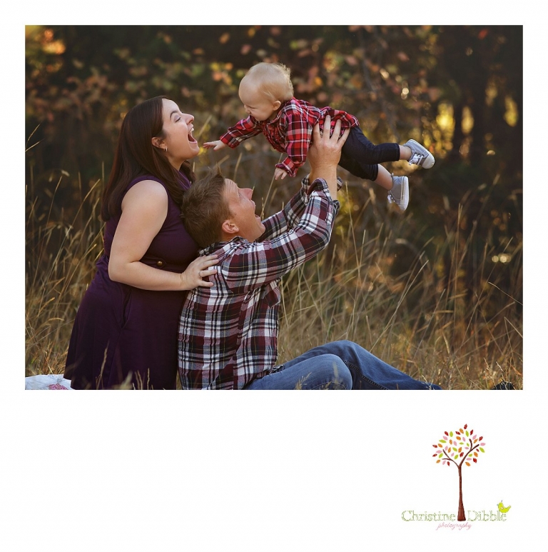 Christine Dibble Photography, child and baby photographer of Sonora, takes first birthday photos of a baby girl in the fall in Twain Harte as she plays with mom and dad for a family portrait.