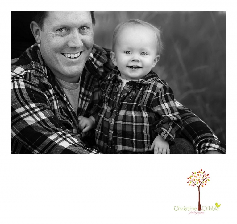 Christine Dibble Photography, child and baby photographer of Sonora, takes first birthday photos of a baby girl in the fall in Twain Harte as she sits with dad for a black and white photo.