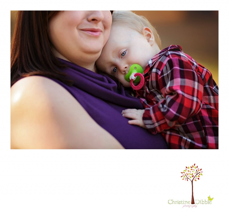 Christine Dibble Photography, child and baby photographer of Sonora, takes first birthday photos of a baby girl in the fall in Twain Harte as she cuddles with mom and her paci.