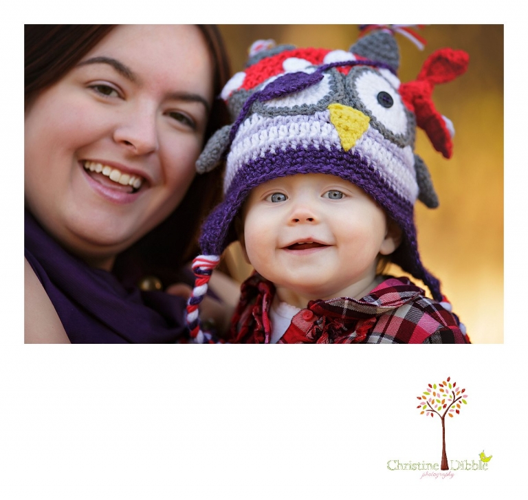 Christine Dibble Photography, child and baby photographer of Sonora, takes first birthday photos of a baby girl in the fall in Twain Harte goofing with mom in an owl birthday hat.