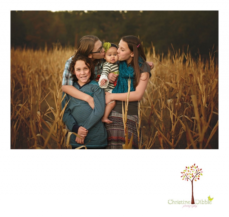 Indigeny Reserve photographer Christine Dibble Photography of Sonora takes photos of four siblings in the corn field during a fall family and first birthday photo session.