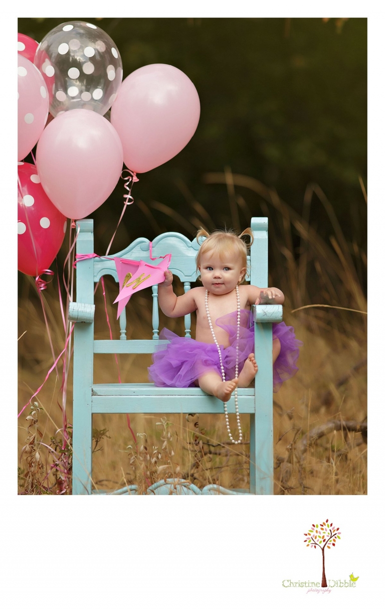 Sonora baby and child portrait photographer Christine Dibble Photography takes outdoor first year photos at a session with polka dot balloons in a field near Twain Harte.