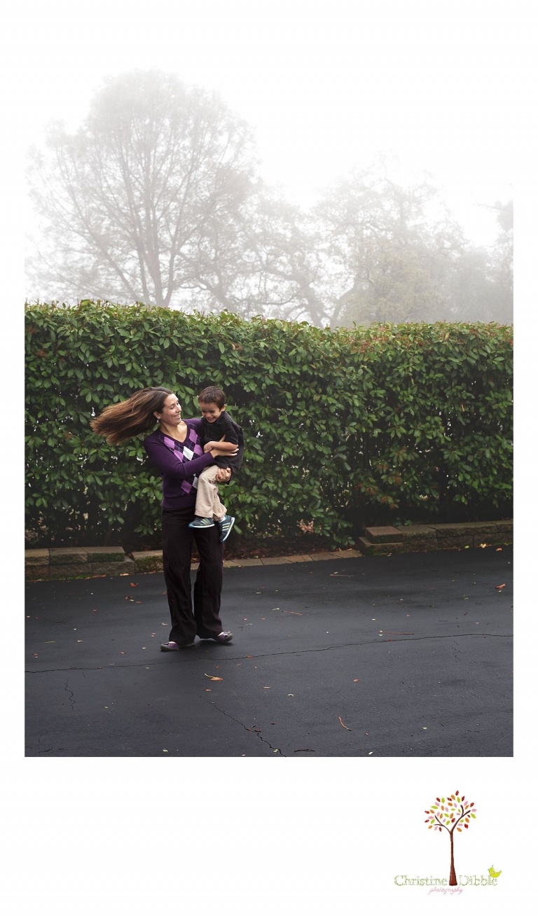 Sonora photographer Christine Dibble Photography takes four generation family portraits outside on a foggy morning in the clients' yard and catches mom swinging her son around.