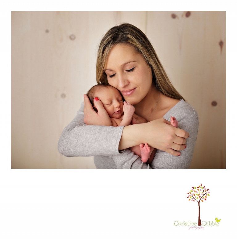 Best Sonora newborn photographer Christine Dibble Photography takes portraits of an eight day old newborn baby girl as she sleeps and snuggles with mom.